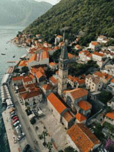 Stunning aerial view of Perast, Montenegro featuring the historic St. Nicholas Church and Adriatic coast.