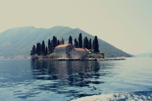 Explore the tranquil island monastery set against stunning Montenegro hills and waters.